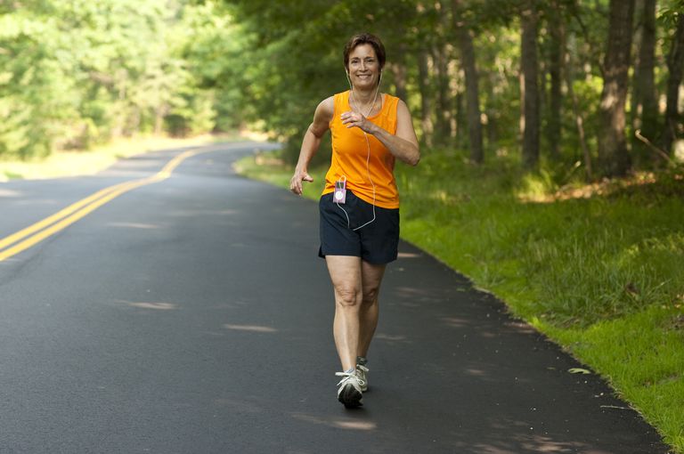 woman powerwalking on road