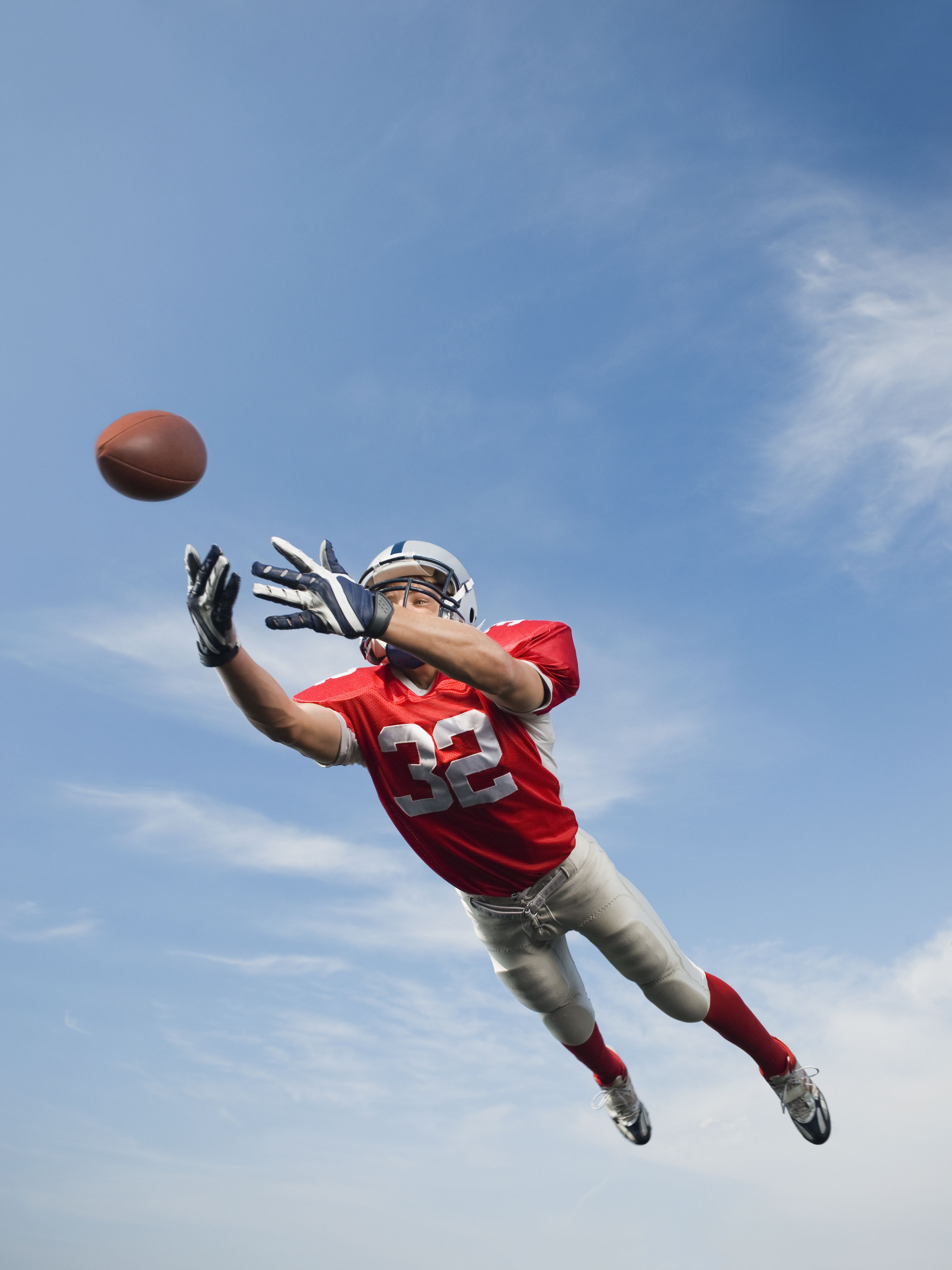 football-player-in-mid-air-reaching-for-