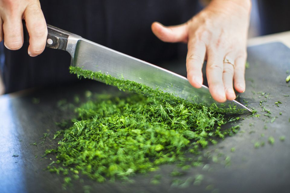 Cutting herbs with chef's knife