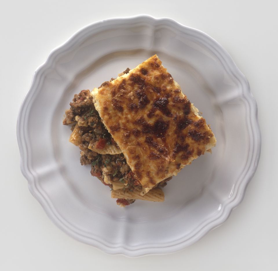 Pastitsio, Greek macaroni, meat and tomato dish baked with bechamel sauce, served on a plate, view from above