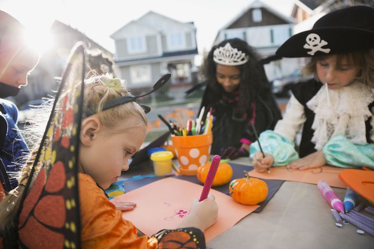 Kids in Halloween costumes coloring