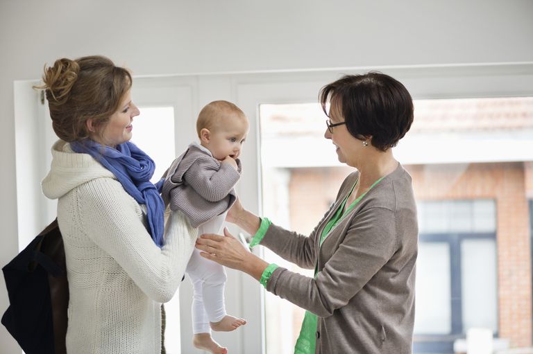 Woman giving her daughter to nanny