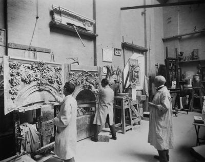 6th June 1928: Sculptor W B Fagan supervises his assistants as they work on a pair of ornamental fireplaces in his studio.