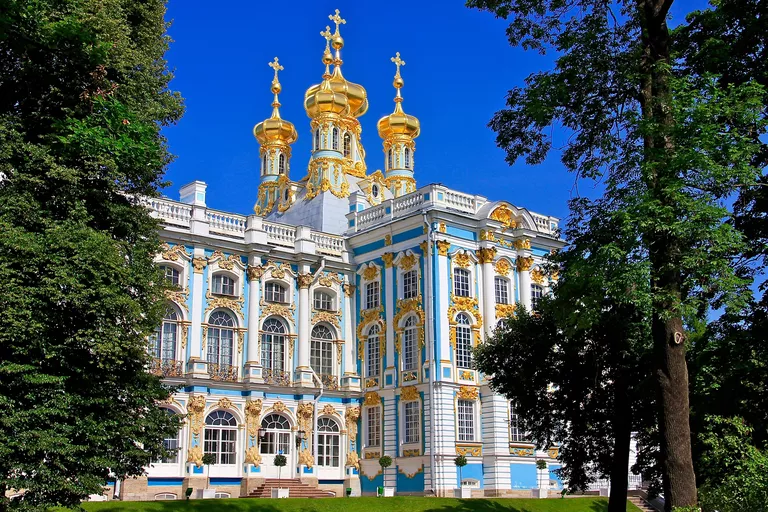 ornate palace exterior with gold towers and blue, white, and gold facade