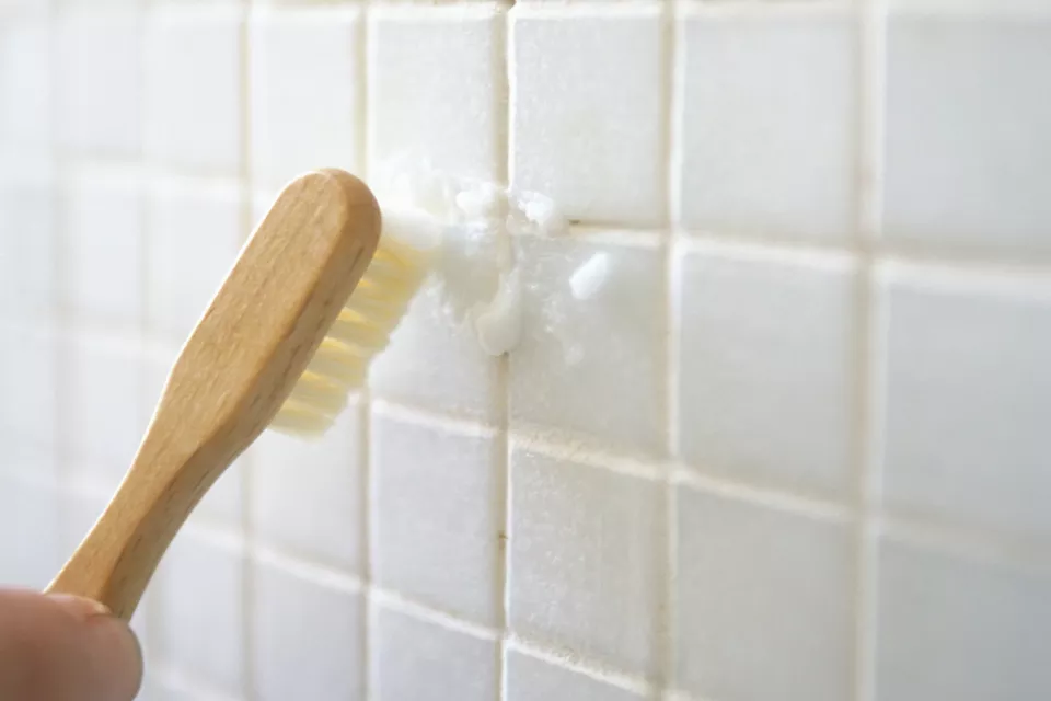 Cleaning tile grout with toothbrush