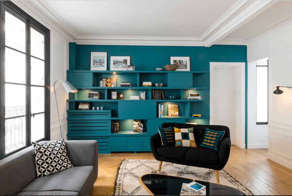 living room with teal accent wall