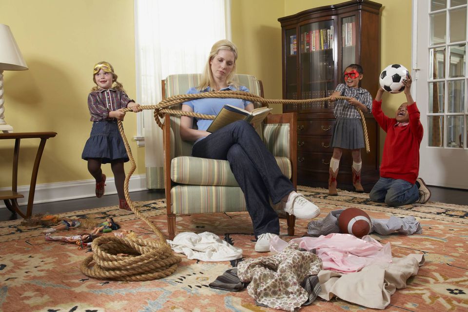 A picture of a mom being tied up as she's trying to read a book