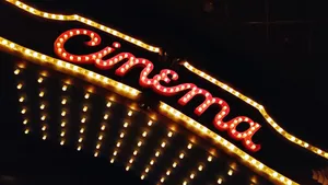 Low Angle View Of Neon Cinema Sign At Night