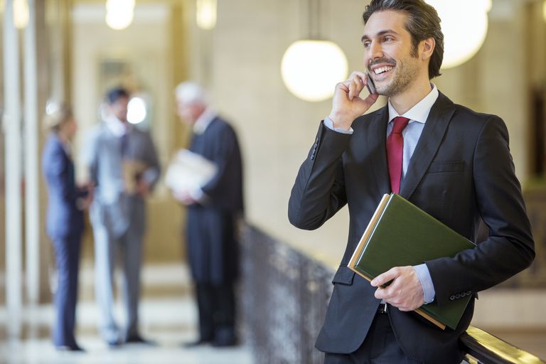 young lawyer talking on cell phone in courthouse