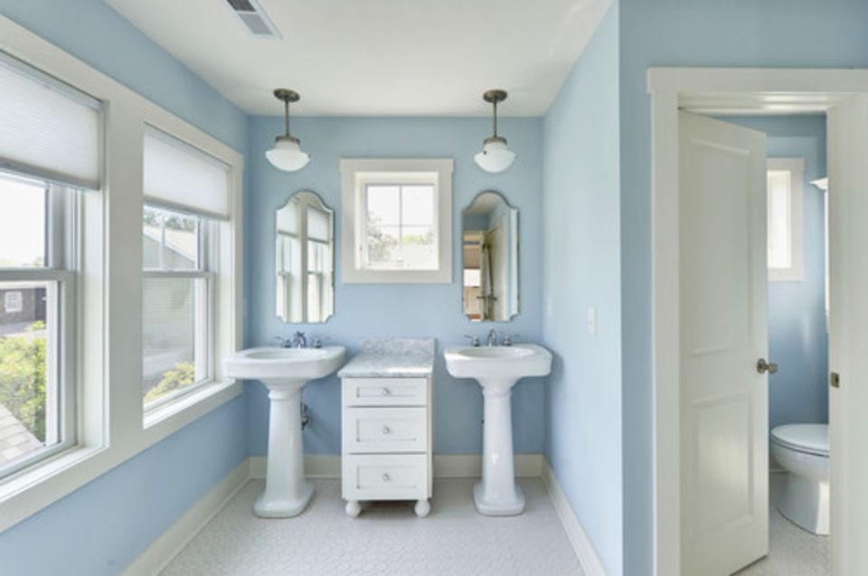two pedestal sinks in small bathroom