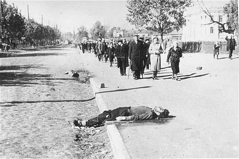 Jews, on their way out of the city of Kiev to the Babi Yar ravine, pass corpses lying on the street.