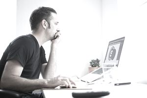 Man working at computer in an open plan office