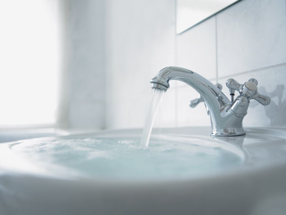 water draining over fluted bathroom sink flange