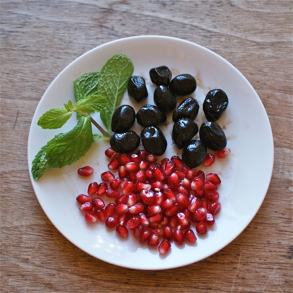 a plate of pomegranates and olives