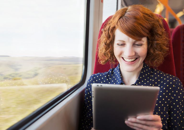 Woman using tablet on a train