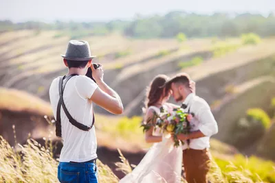Freelance photographer photographing bride and groom