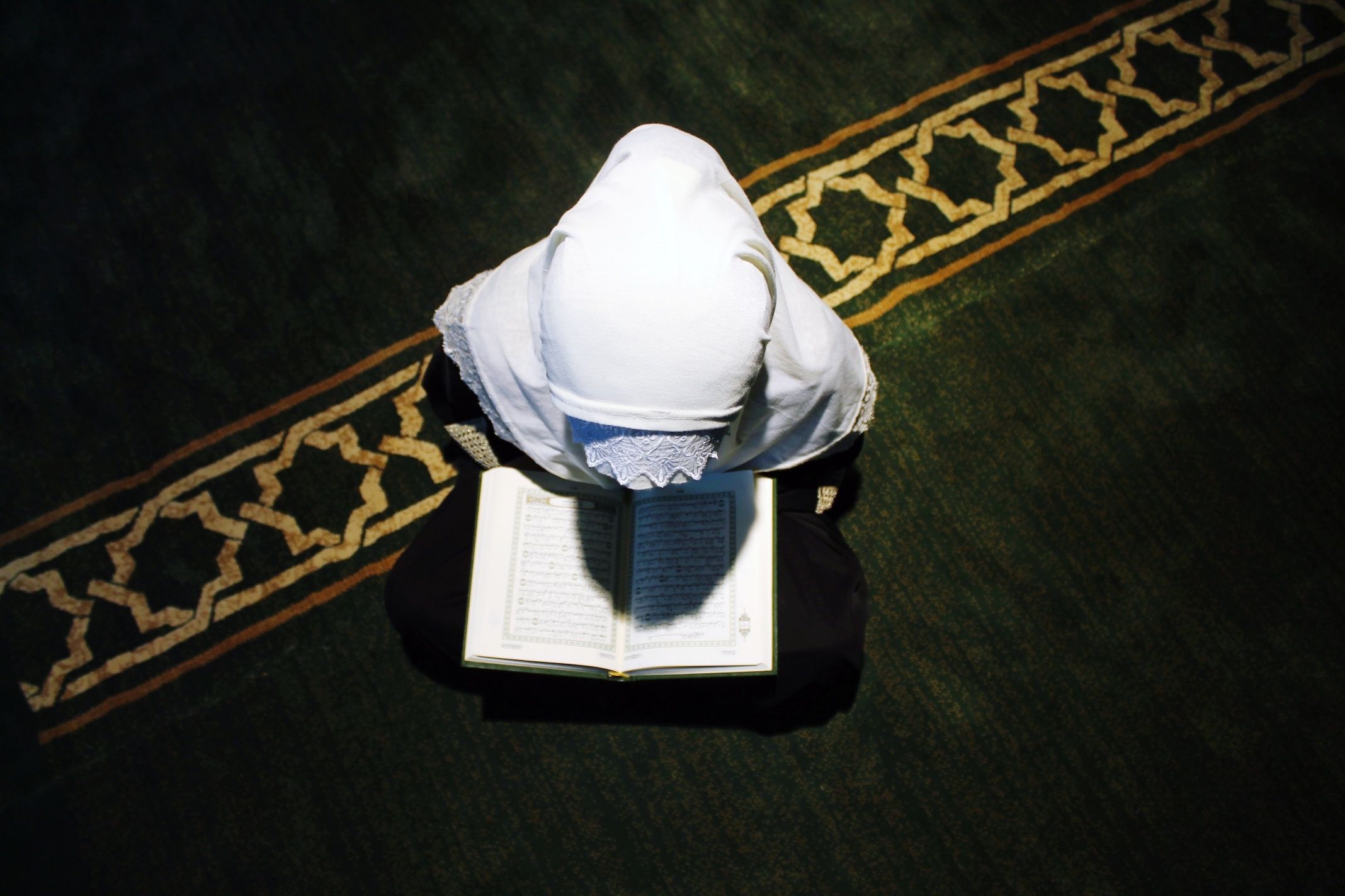 High Angle View Girl Wearing Hijab Reading Koran During Ramadan