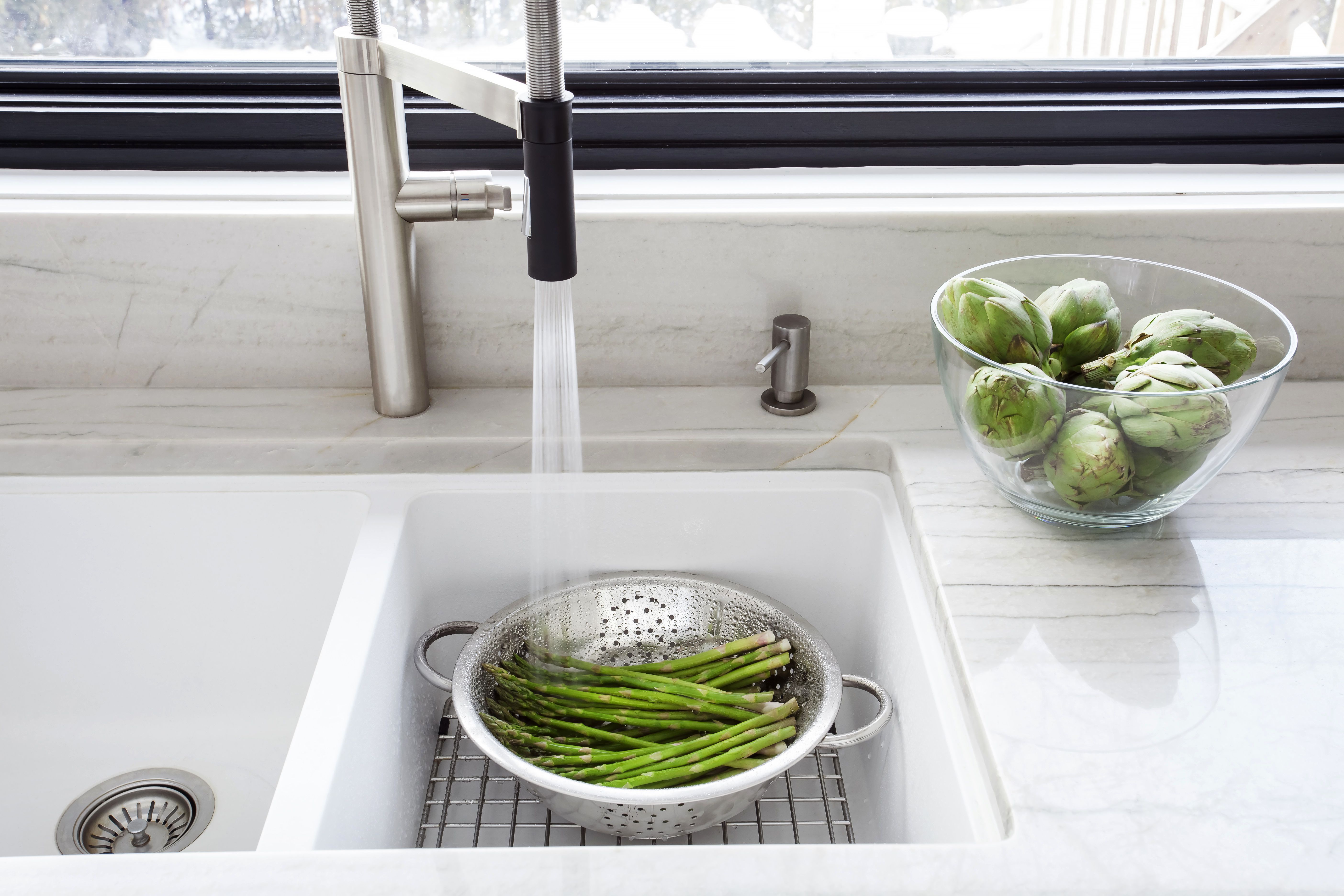 Washing Fresh Asparagus In The Kitchen Sink  518962978 5a960501ae9ab8003749ee74 