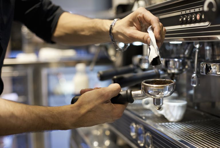 barista making coffee, close-up of hands