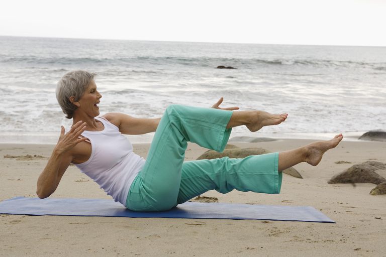 Woman doing pilates on beach, Malibu, California