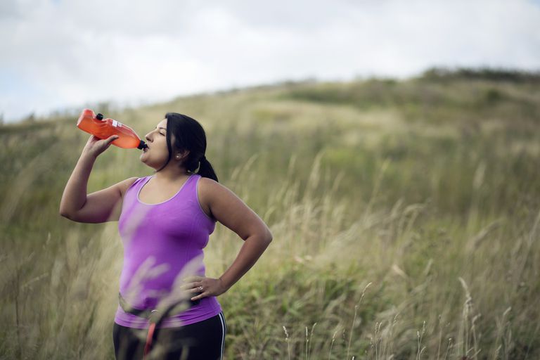 Female jogger drinking water