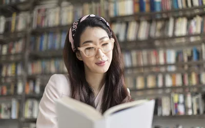 Portrait of beautiful woman reading a book