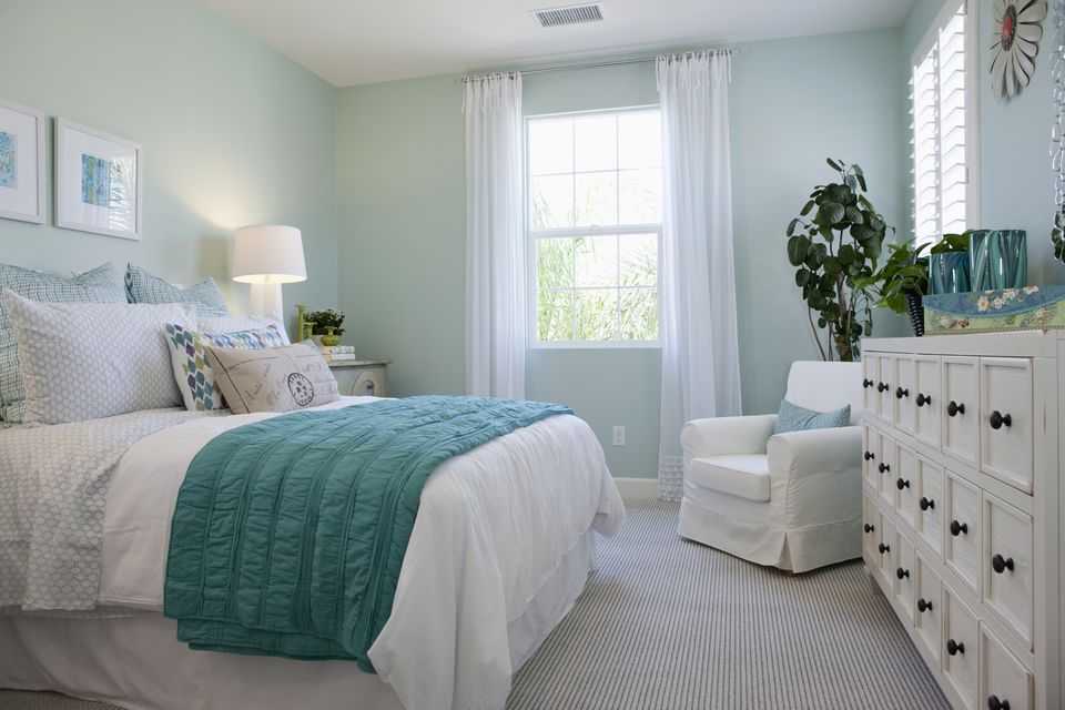 pastel bedroom with dark furniture