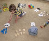 A boy plays a counting game