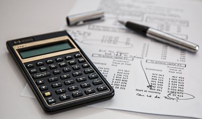 calculator and paper with financial figures