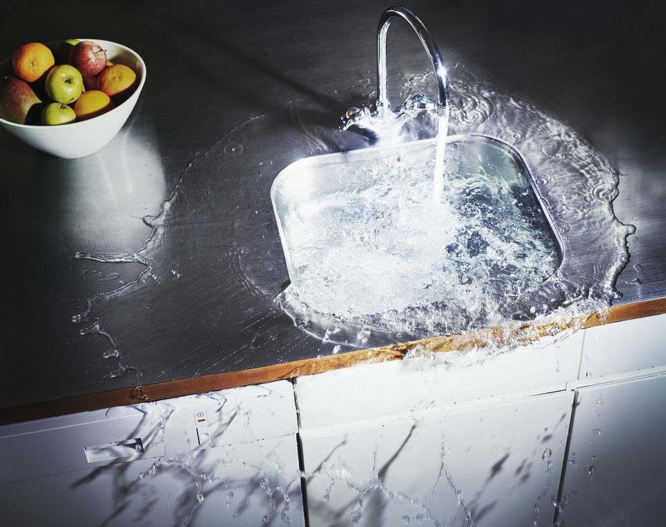 kitchen sink overflowing with water