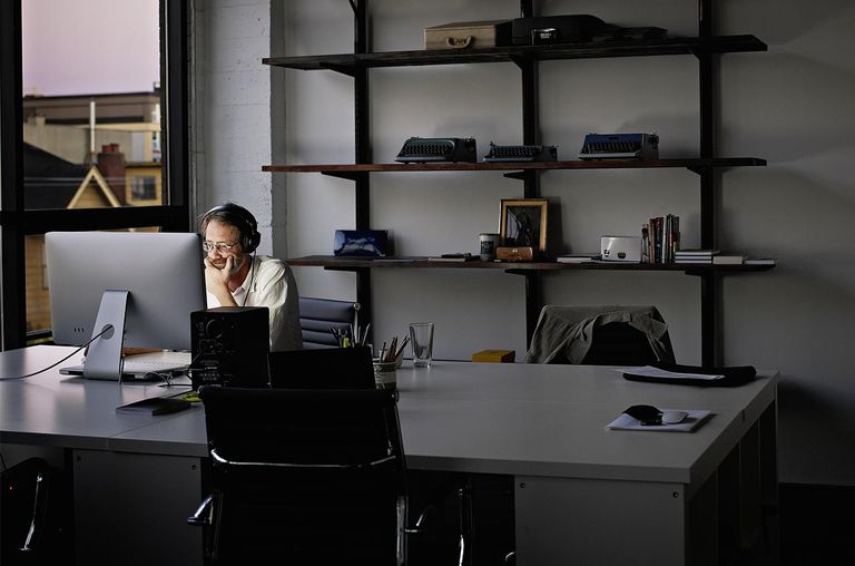 Businessman sitting working on computer at night