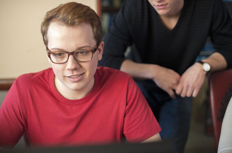 Teacher helping student at computer