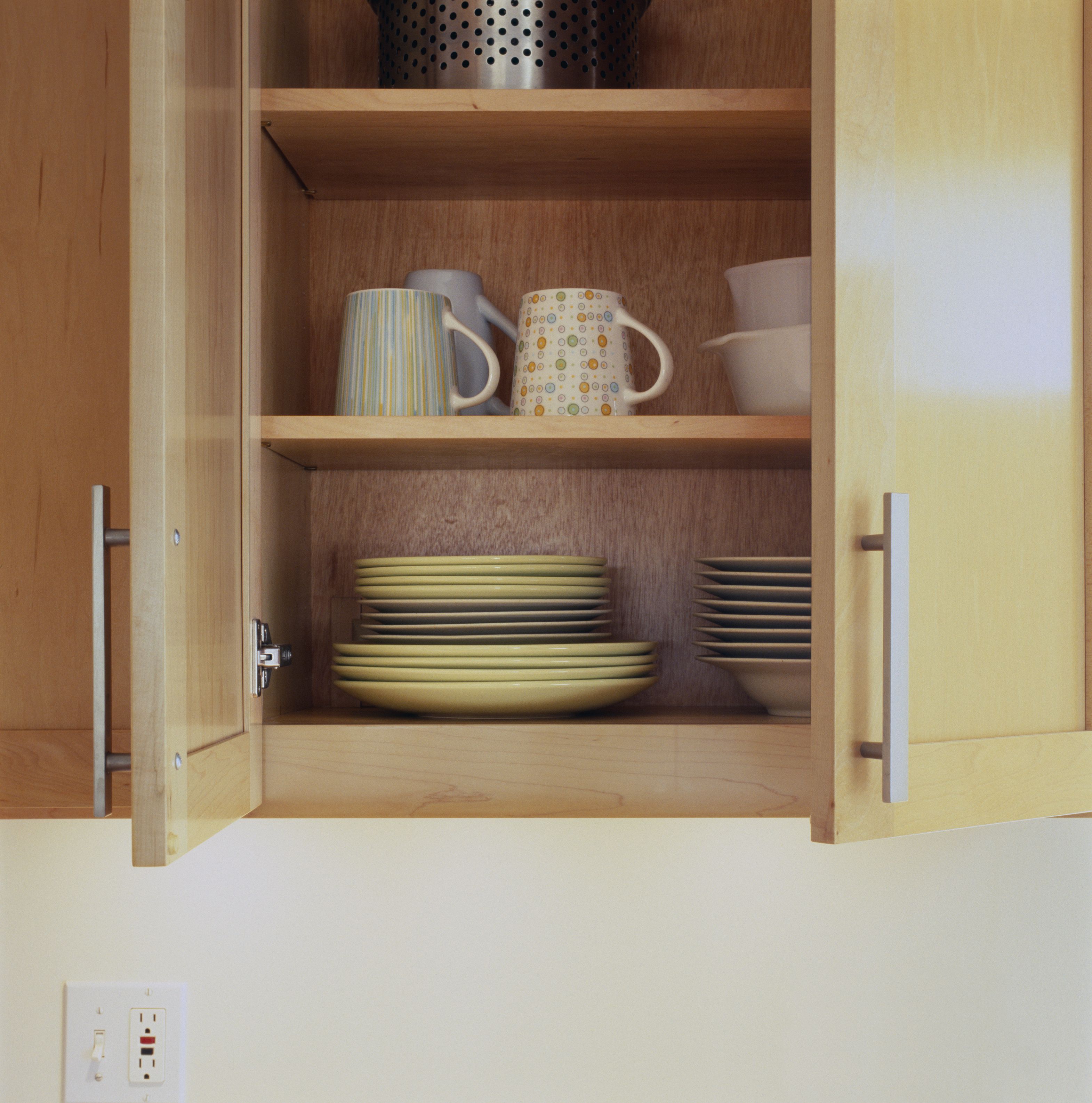 Dishes In Open Kitchen Cabinet Close Up 200364123 001 57e9ea285f9b586c353a0570 