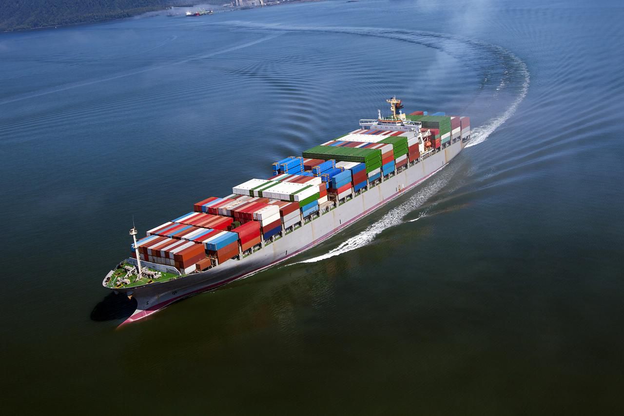 international-container-cargo-ship-in-the-ocean-at-sunset-sky-freight