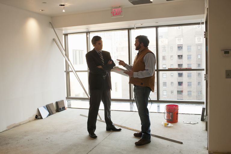 Foreman talks to architect in empty room