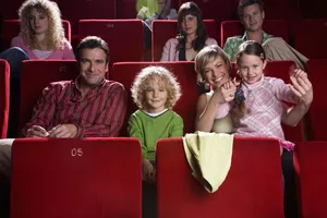 Family sitting in movie theater