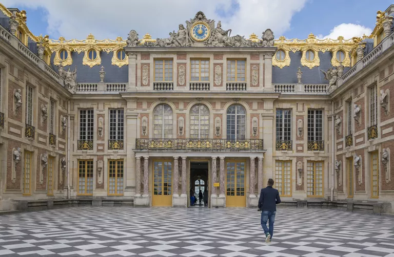 ornate entrance to The Palace of Versailles in France