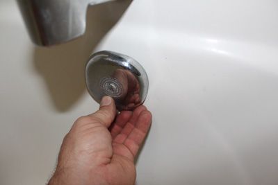 bathtub overflow plate hole go up or down