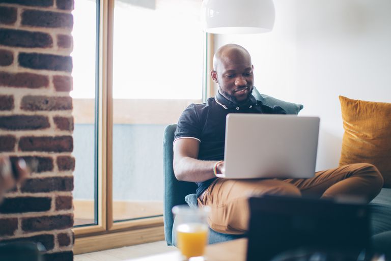 man working on laptop in his living room