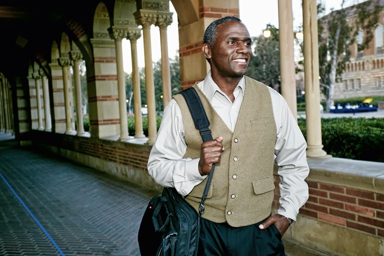 Mature male student smiling on campus