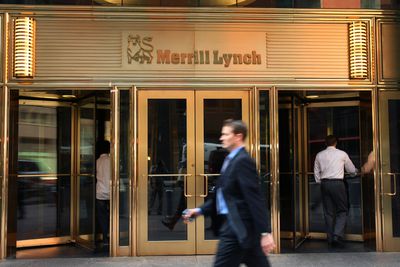 Pedestrians walk past Merrill Lynch offices in New York City