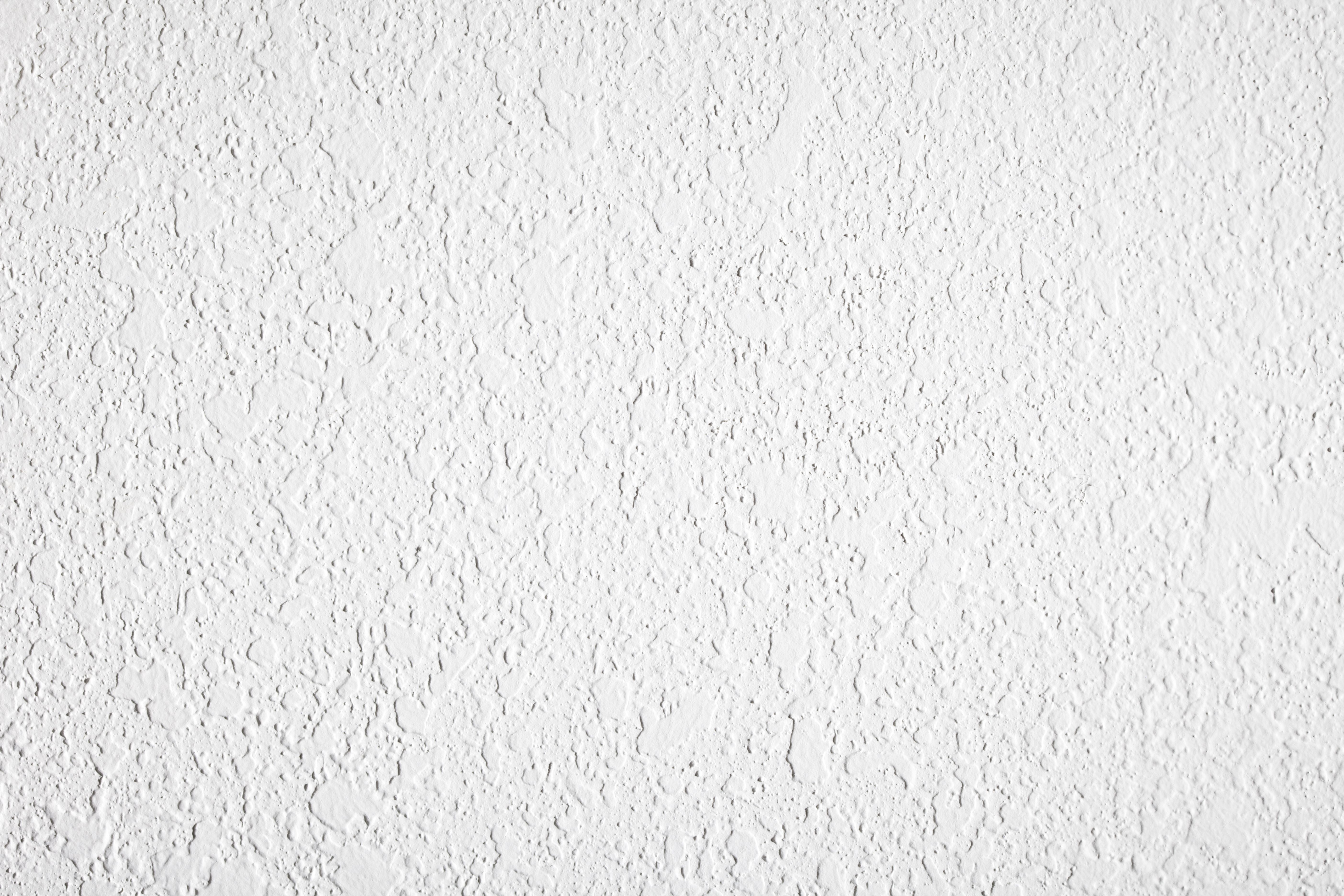 high contrast textured white plaster wall 157564036 5893cb0c5f9b5874ee2d79f1