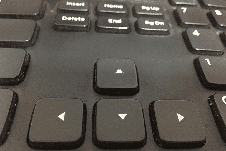 Photo of arrow keys on a black keyboard