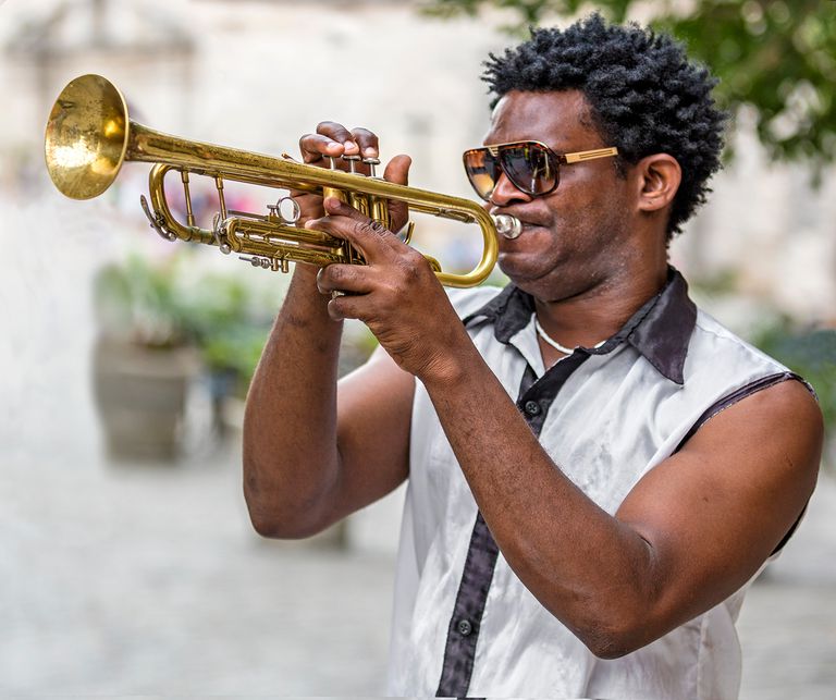 Cuba, Havana, Plaza de San Francisco de Asis, Cuban trumpet player entertains passers by.