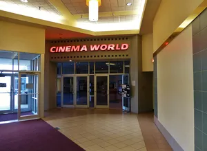 The entrance of a Cinema World movie theater.