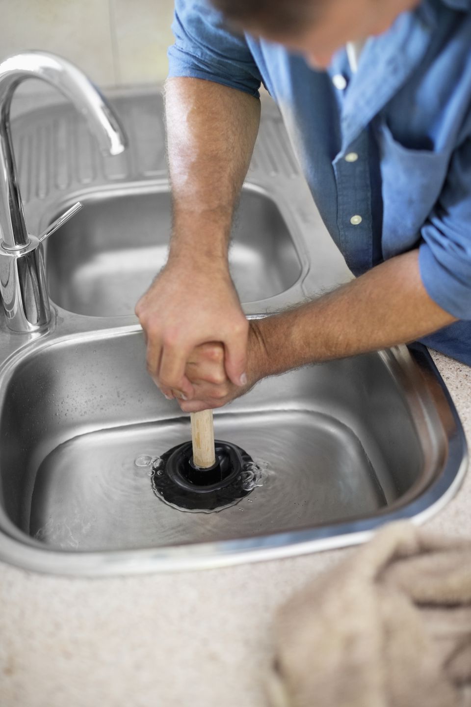 Three Simple Ways To Unclog A Sink Drain   Plumber Unclogging Kitchen Sink 169270382 5810e7bb5f9b58564c5dd92b 