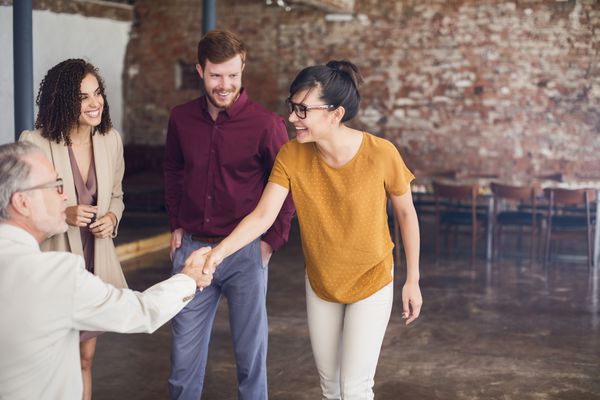 Friendly people smiling and shaking hands