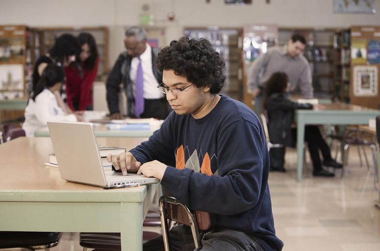 Student with laptop in school library