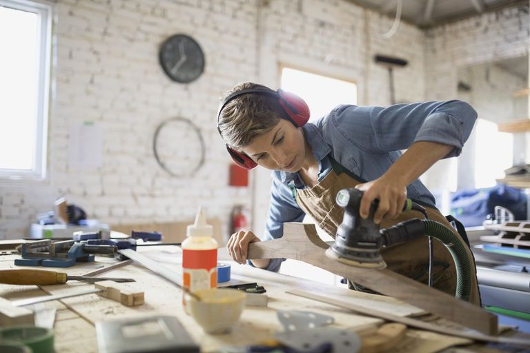 female carpenter working in shop