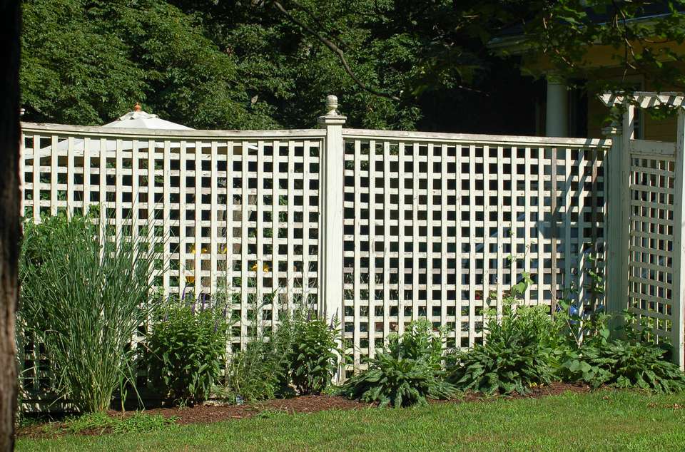 old fashioned heavy wooden lattice panels fencing